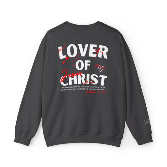 A dark gray crewneck sweatshirt shown from the back, featuring a large graphic print with the words 'LOVER OF CHRIST' in white and red script, along with scripture text and a small heart design.